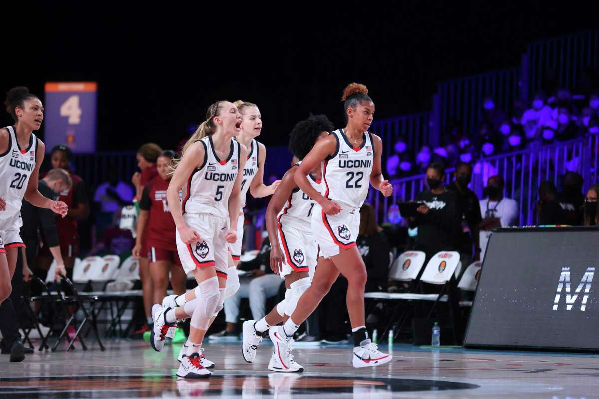 UConn's Paige Bueckers (5) and teammates including Olivia Nelson-Ododa (20), far left, and Evina Westbrook (22), right, react during an NCAA college basketball game against South Carolina at Paradise Island, Bahamas, Monday, Nov. 22, 2021.