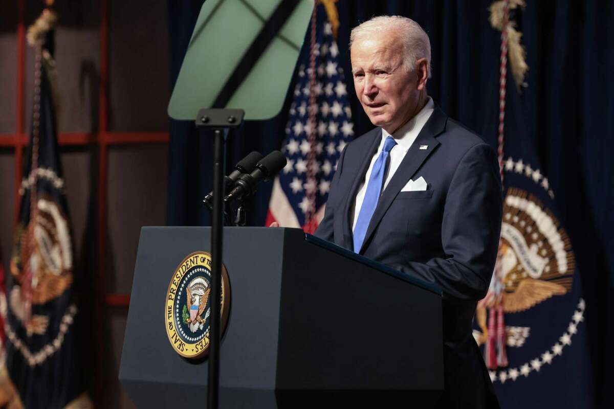 President Biden speaks while visiting the National Institutes of Health in Maryland on Thursday. Biden sketched out his latest plan to quell the pandemic that's dogged his presidency, with two U.S. cases of the omicron variant now confirmed and threatening to fuel an already high case count.