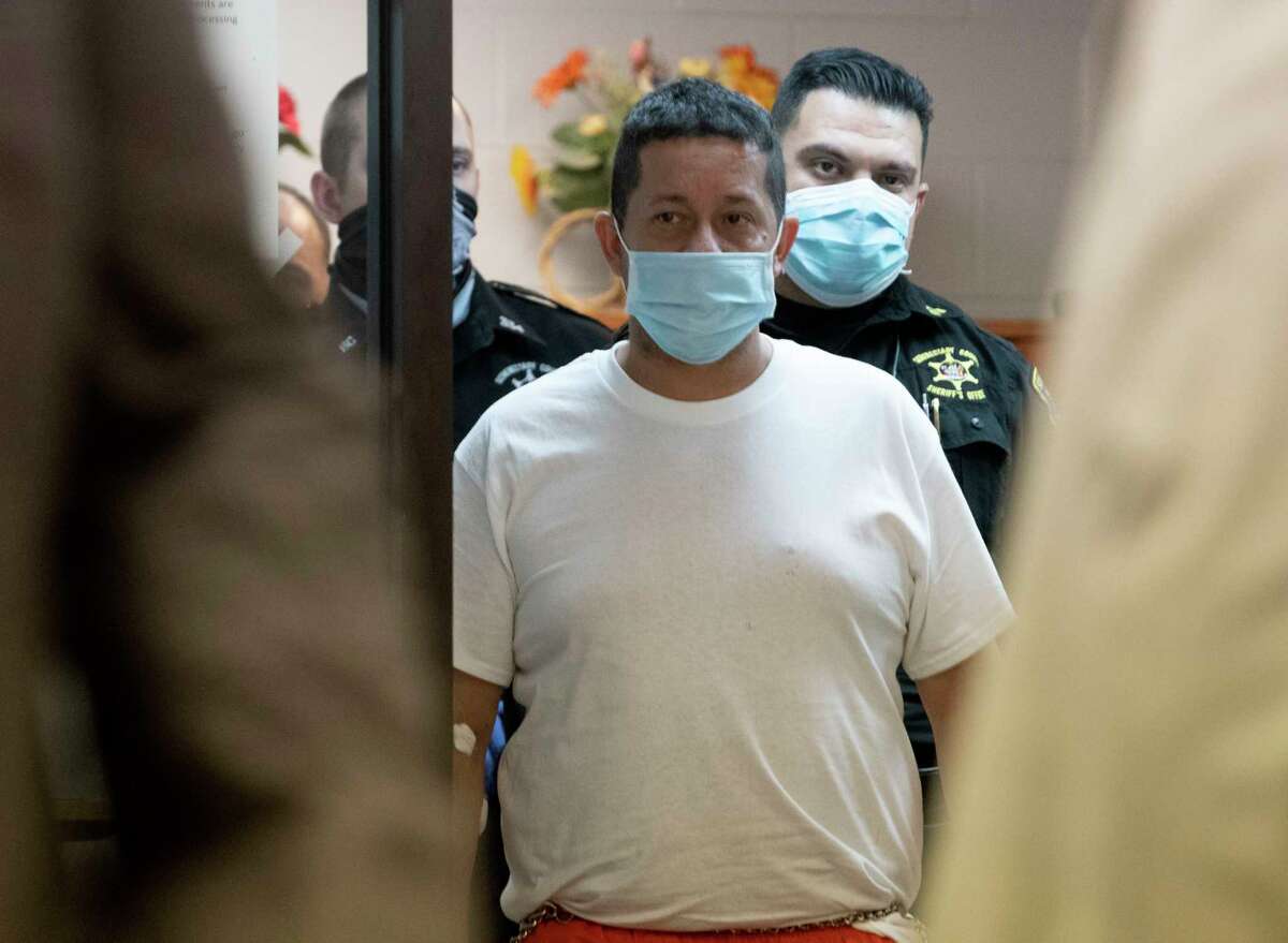 Nelson D. Patino, 47, is lead into Duanesburg Town Court on Thursday, Dec. 2, 2021 in Duanesburg, N.Y. Patino is charged with second-degree murder and other offenses after a rampage that also left second child with stab wounds on Wednesday night.
