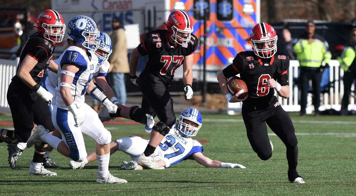 New Canaan quarterback Henry Cunney (6) breaks loose for a long run against Darien during the Turkey Bowl football game at Dunning Field on Thursday, Nov. 25, 2021.