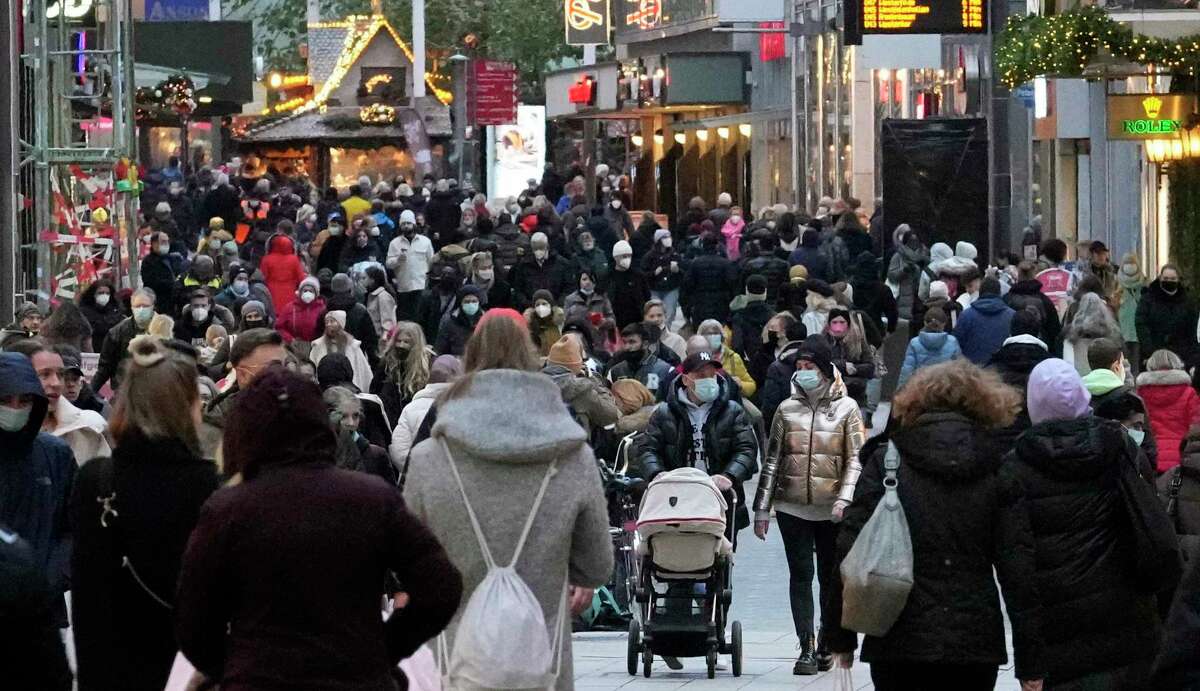 People wear mandatory face masks in a shopping street in Dortmund, Germany, Dec. 1, 2021. Germany tightened the COVID-19 rules because of the pandemic. Germany's outgoing Chancellor Angela Merkel and her likely successor met with state governors to consider tighter rules to curb coronavirus infections. The rise in COVID-19 cases over the past weeks and the arrival of the new omicron variant have prompted warnings from scientists and doctors that medical services in the country could become overstretched in the coming weeks unless drastic action is taken.