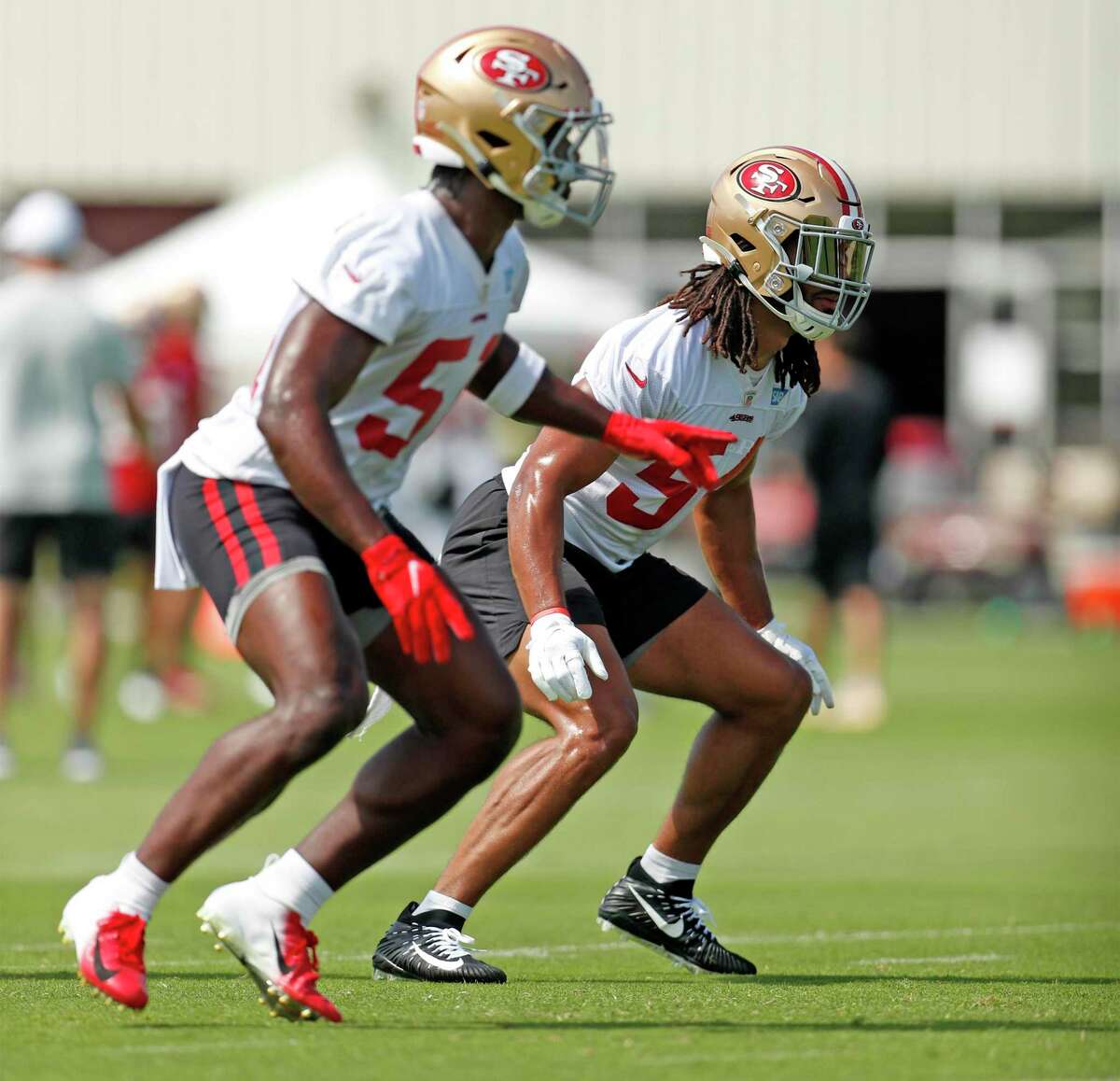 San Francisco 49ers' Fred Warner (right) and Azeez Al-Shaair during training camp at Levi's Stadium practice field in Santa Clara, Calif., on Wednesday, July 28, 2021.