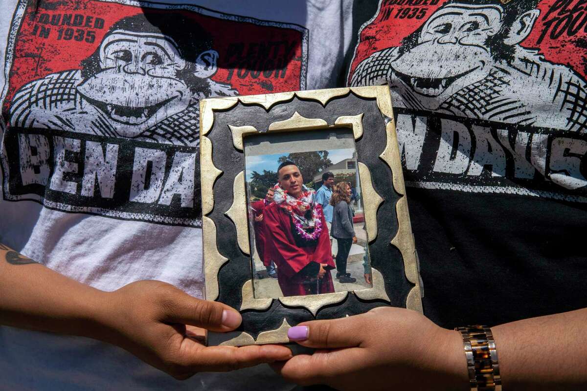 Michelle Monterrosa and her sister Ashley Monterrosa hold a portrait of their brother Sean Monterrosa on Thursday, June 4, 2020, in San Francisco, Calif. Sean Monterrosa, 22, was fatally shot by Vallejo police.