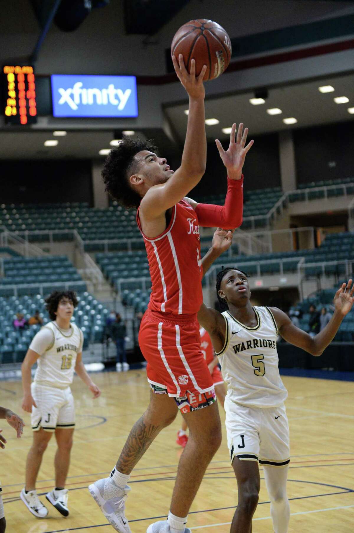 Dayvaughn Froe (4) of Katy drives to the basket in the second half of a pool game between the Katy Tigers and the Jordan Warriors during the Katy ISD Basketball Classic on Thursday, December 2, 2021 at the Leonard Merrill Center, Katy, TX.