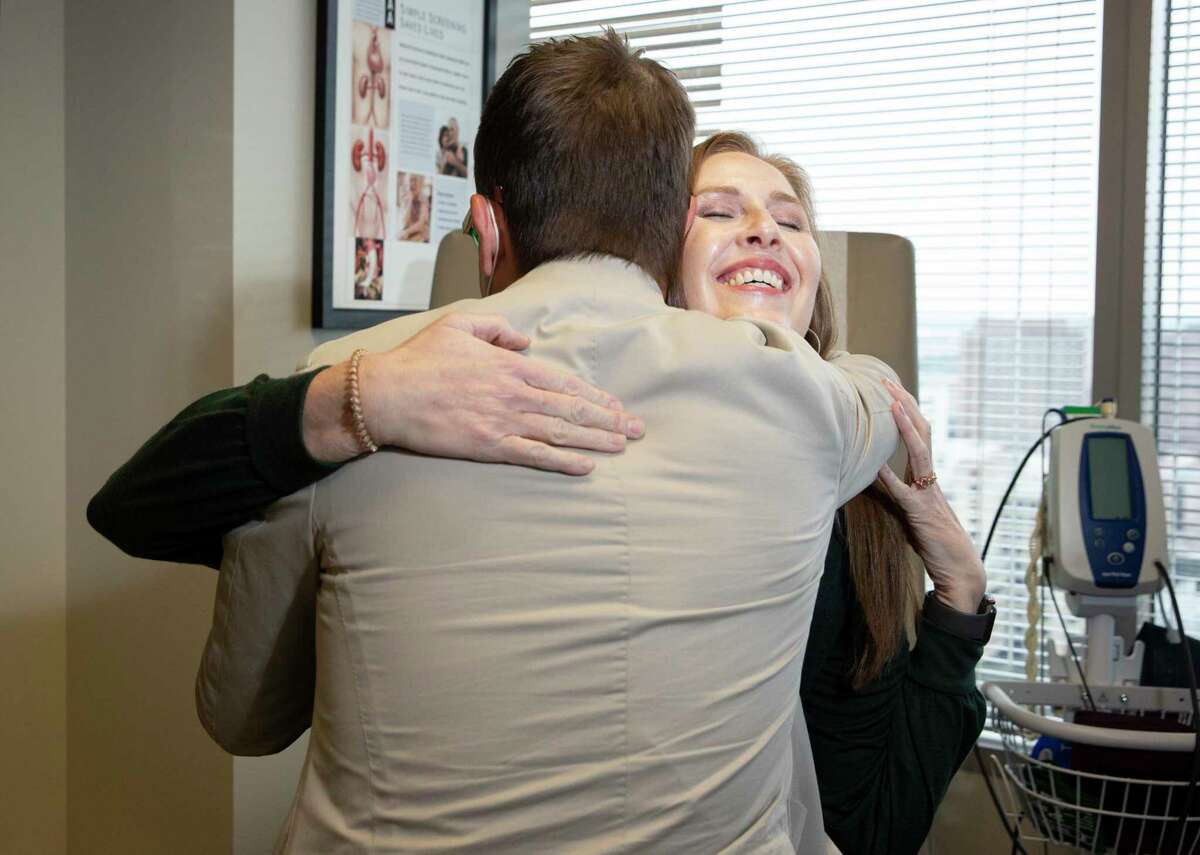 Anne Accardo meeting embraces Dr. Gustavo Oderich, vascular surgeon McGovern medical school at UTHealth Houston,UT Physicians and Memorial Hermann, for a check-up two months after her surgery Thursday, Nov. 4, 2021, at UT Physicians, the clinical practice of UTHealth Houston, in Houston. Oderich created a customized stent just for her aneurysm surgery.