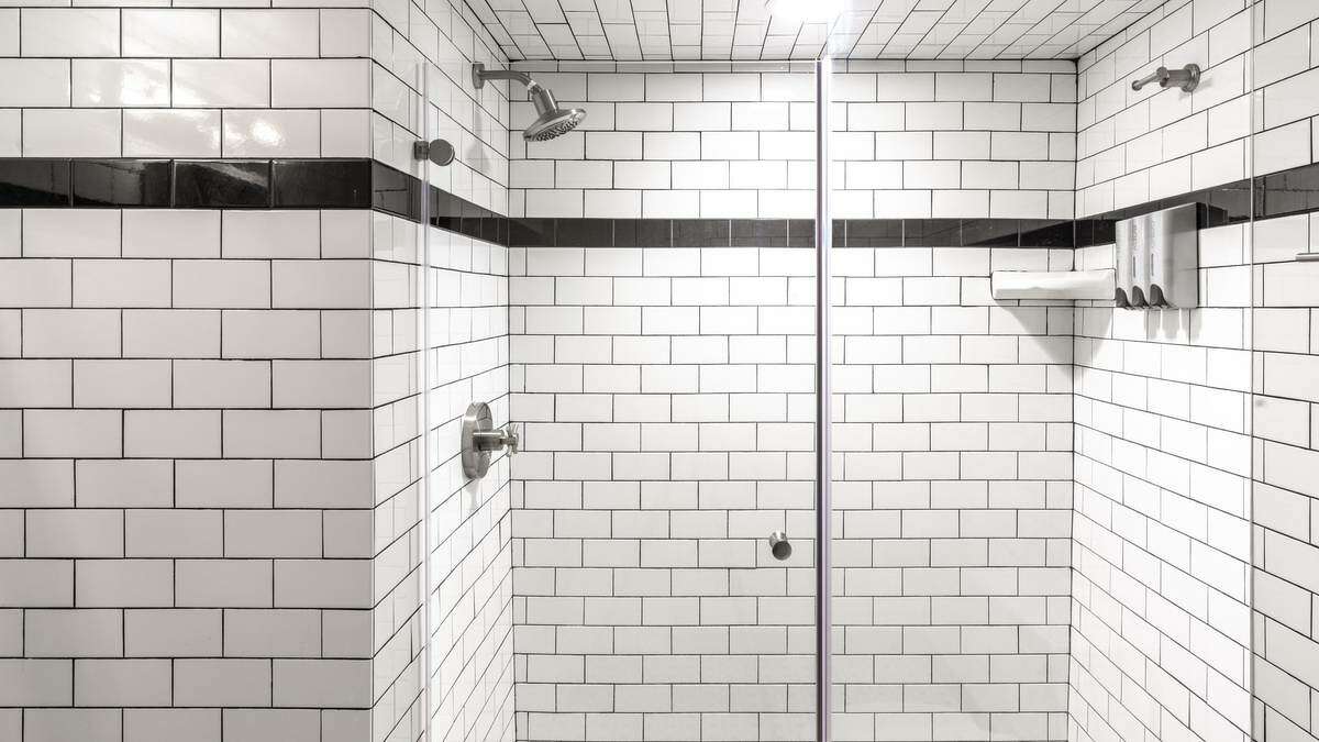 The bathroom tiles remind me of a retro subway station.