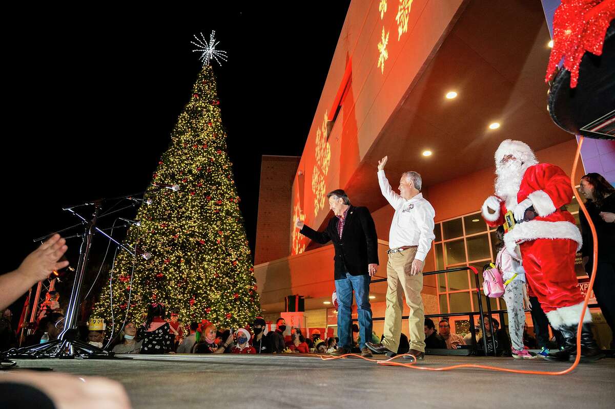 Mayor Pete Saenz, Councilmember Mercurio Martinez III and Santa Claus celebrate as the tree outside the Sames Auto Arena is lit Wednesday, Nov. 1, 2021, during Navidadfest.