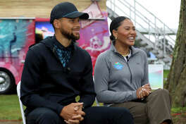 Stephen Curry and Ayesha Curry speak at The Workday Charity Classic, hosted by Stephen and Ayesha Curry's Eat. Learn. Play. and Workday, at Franklin Elementary School on September 10, 2021 in Oakland, California.