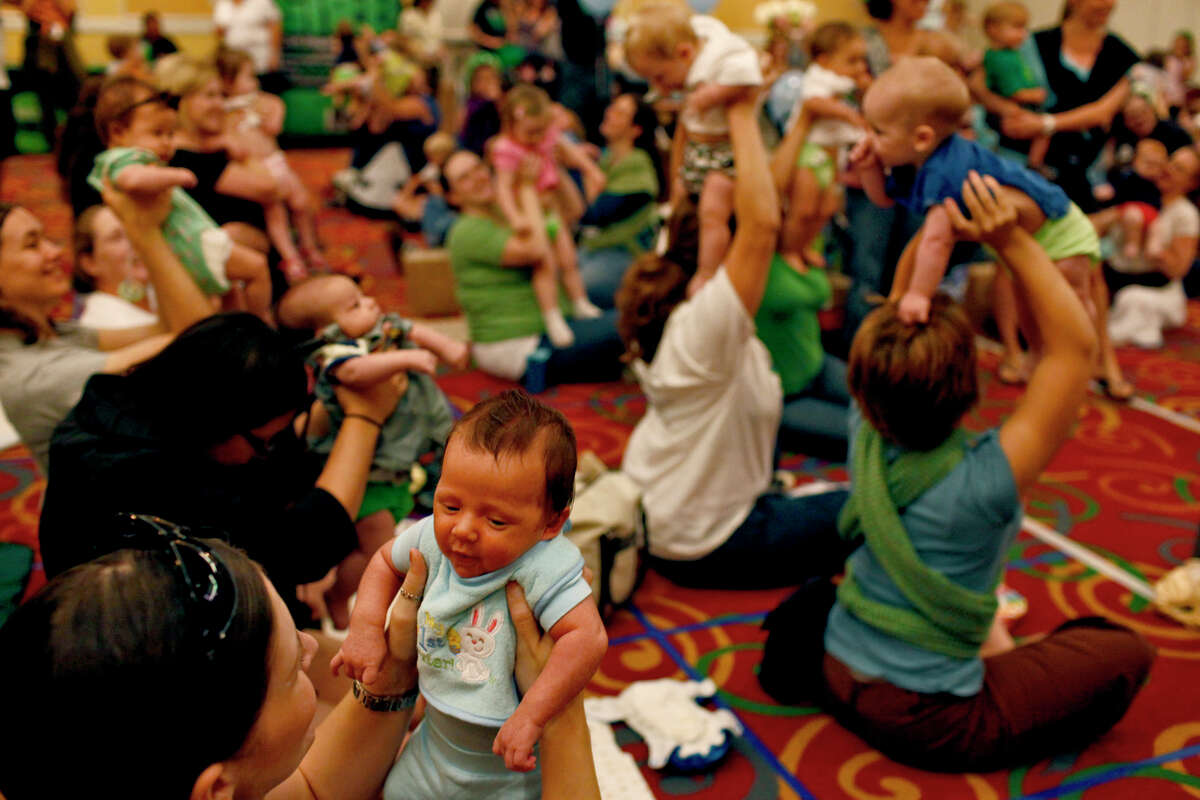 Brooke Bueno holds up her son, Braxton Bueno, six weeks old, as a photo is made to send to the Guinness World Records after Braxton and 72 other children had a diaper change during The Great Cloth Diaper Change at a La Quinta hotel in San Antonio on Saturday, April 23, 2011.