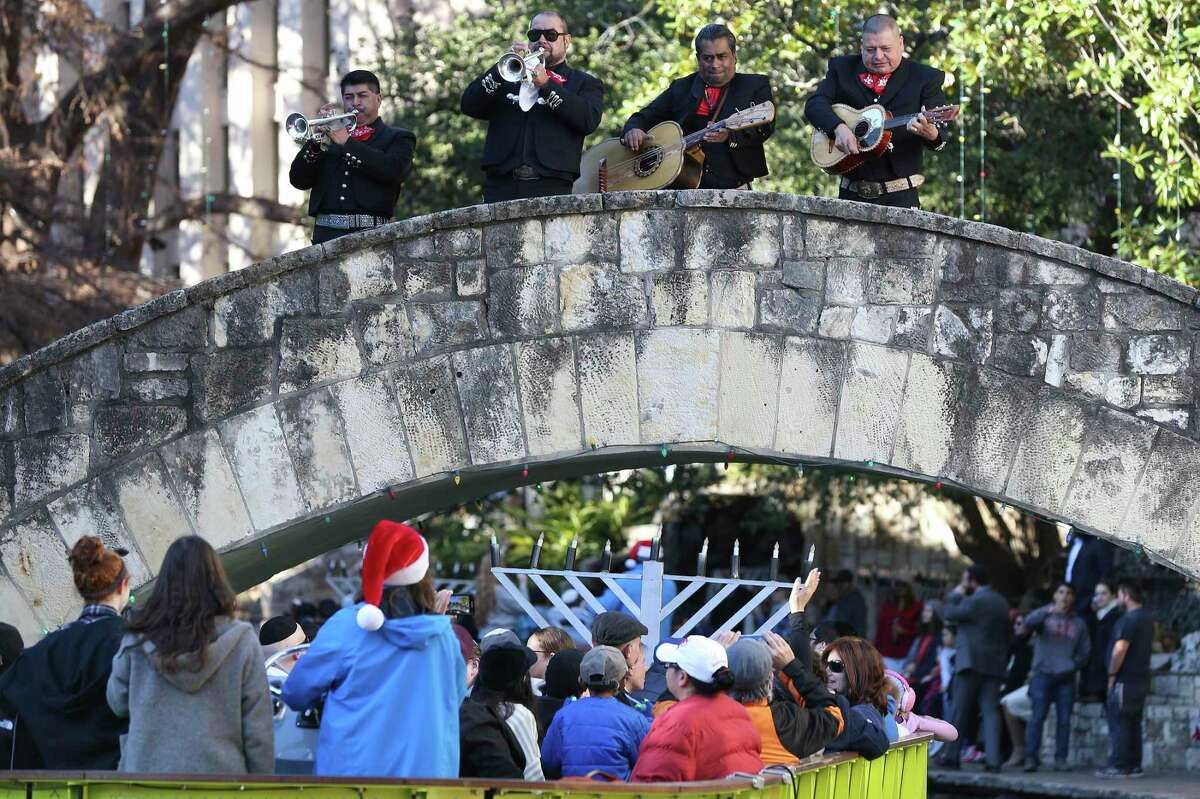 A barge carrying a menorah goes under Rosita’s Bridge as Mariachi Diamante performs Dec. 9, 2018, during the 21st annual Chanukah on the River at the Arneson River Theatre in San Antonio.