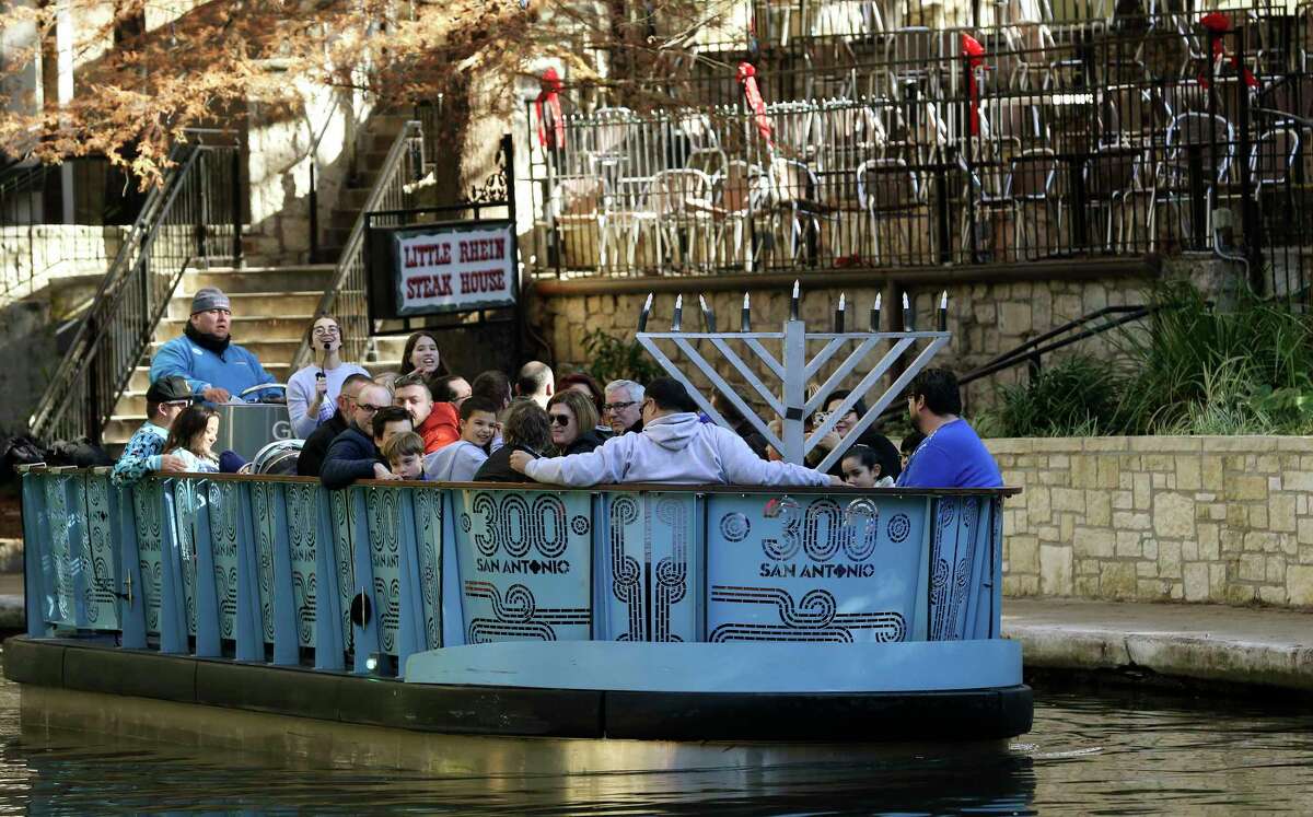 A barge carries a menorah as the San Antonio Jewish community celebrates the 21st annual Chanukah on the River on Dec. 9, 2018, at the Arneson River Theatre in San Antonio.
