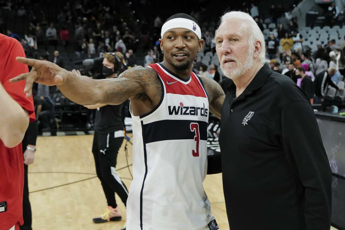 Washington Wizards' Bradley Beal, left, talks with San Antonio Spurs coach Gregg Popovich after an NBA basketball game on Nov. 29. Popovich, who has coached the Spurs since 1996, holds the NBA record for the most seasons coaching the same team.