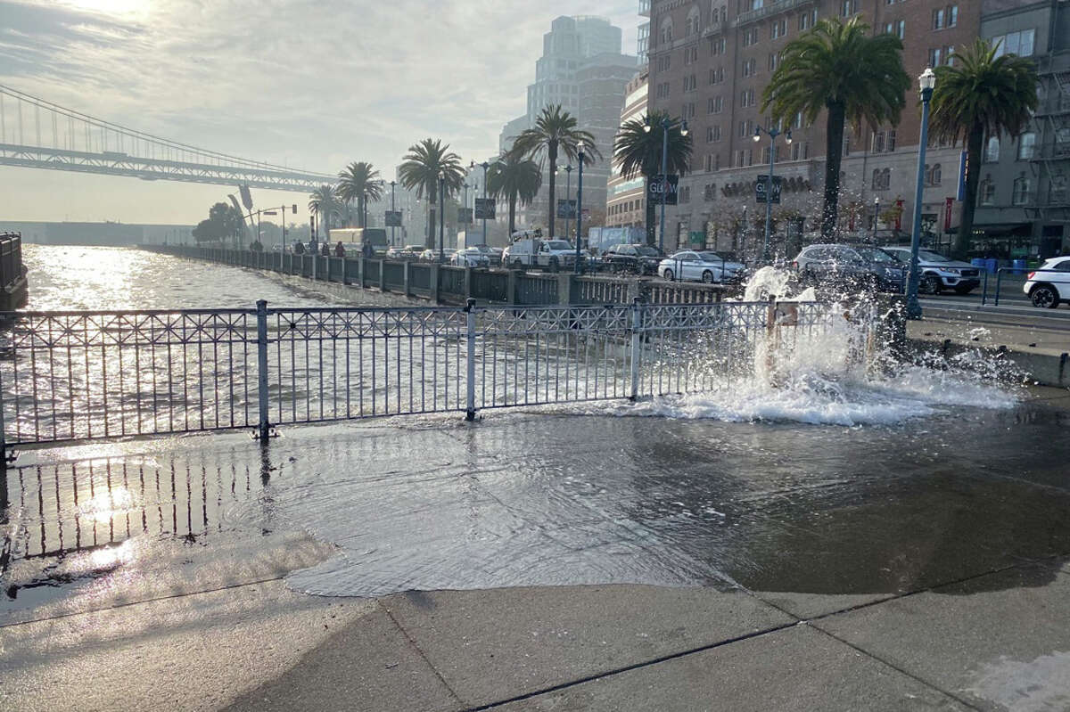 Water from San Francisco Bay spills onto the Embarcadero on the morning of Thursday, Dec. 2, 2021, during the week of the King Tide. 