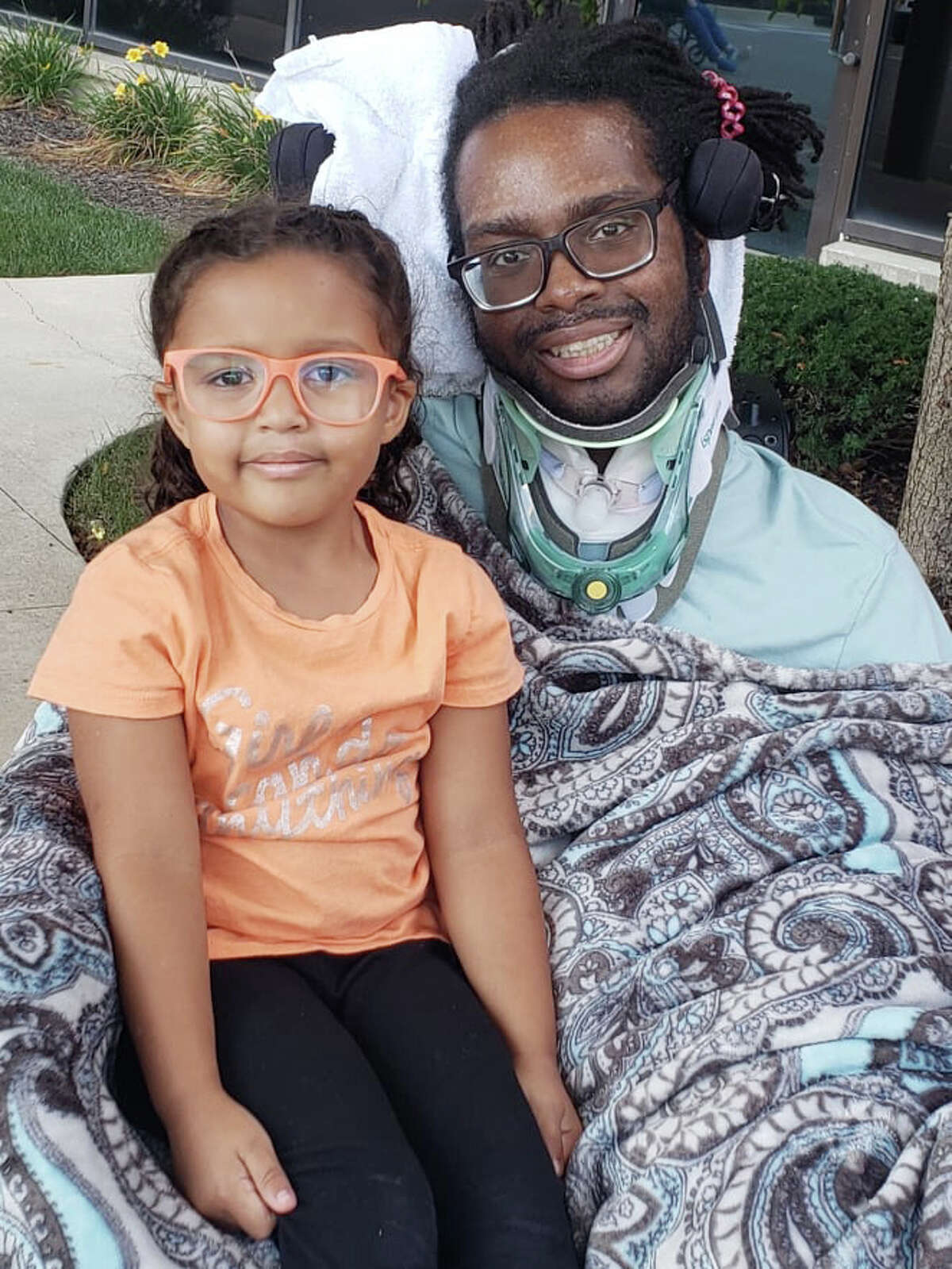 A'Shawny Sneed, a 2006 Big Rapids High graduate, is pictured sharing a smile with his daughter, Ahliya. Sneed was paralyzed from the shoulders down after a tragic car accident in August. His family has started a GoFundMe page in an effort to raise money with the goal of purchasing reliable transportation to take Sneed to and from doctor's visits.
