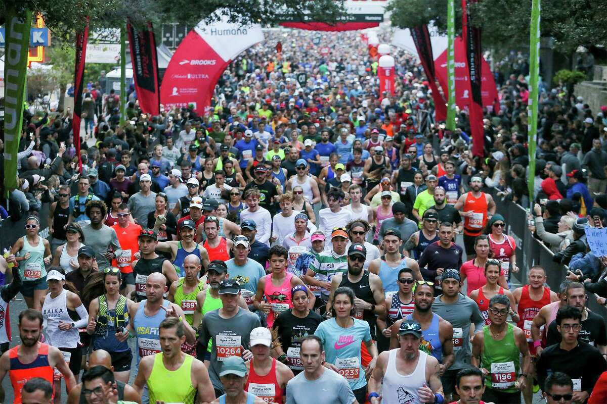 Runners take off from the starting line of the Rock 'n' Roll San Antonio Marathon on West Market Street on Sunday, Dec. 8, 2019.