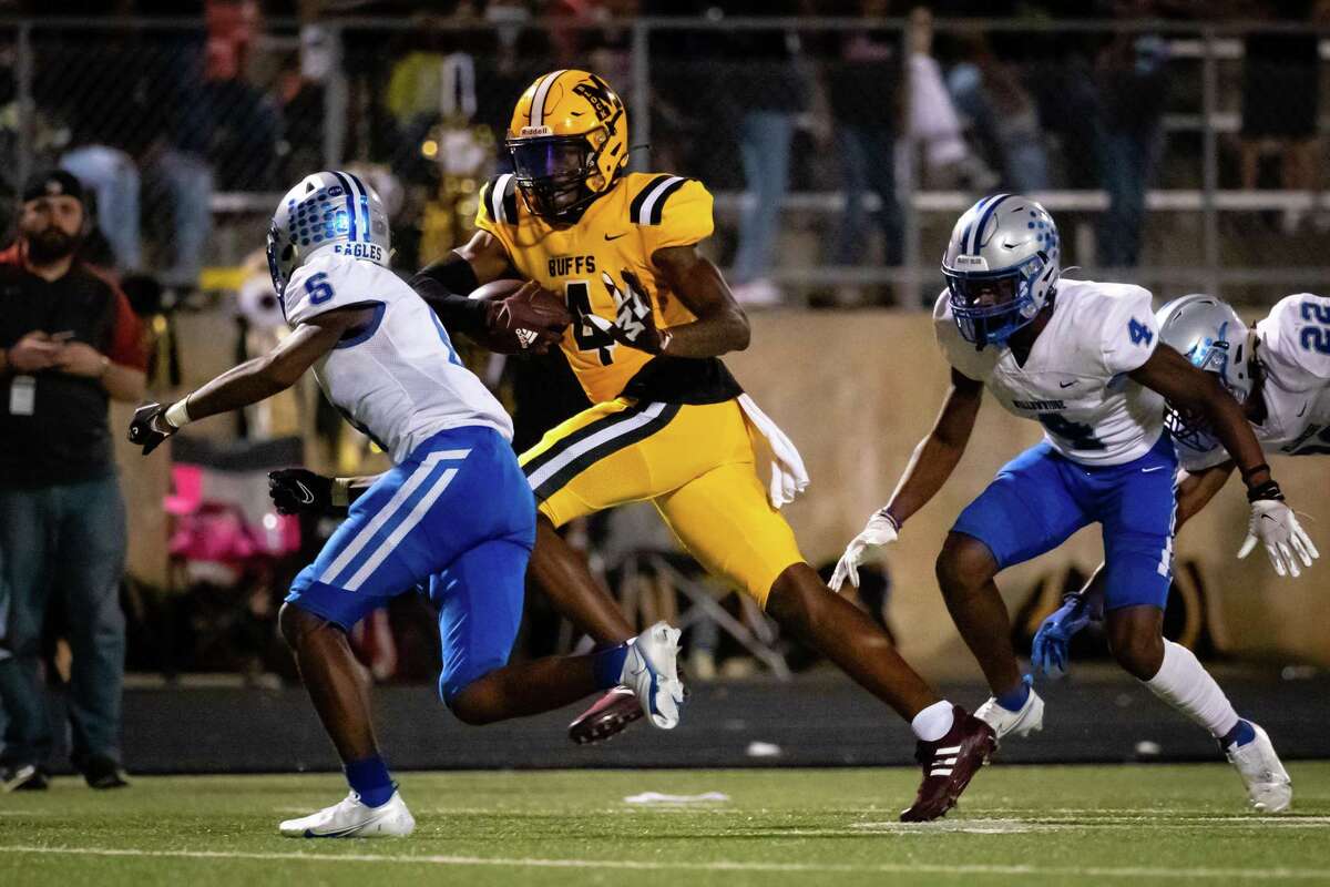 Marshall receiver Chris Marshall (4) stiffarms past Willowridge defensive back Marxquise Hayes (6) for a touchdown in the second half of a district 11-5A high school football game Friday, Oct 15, 2021, in Missouri City.