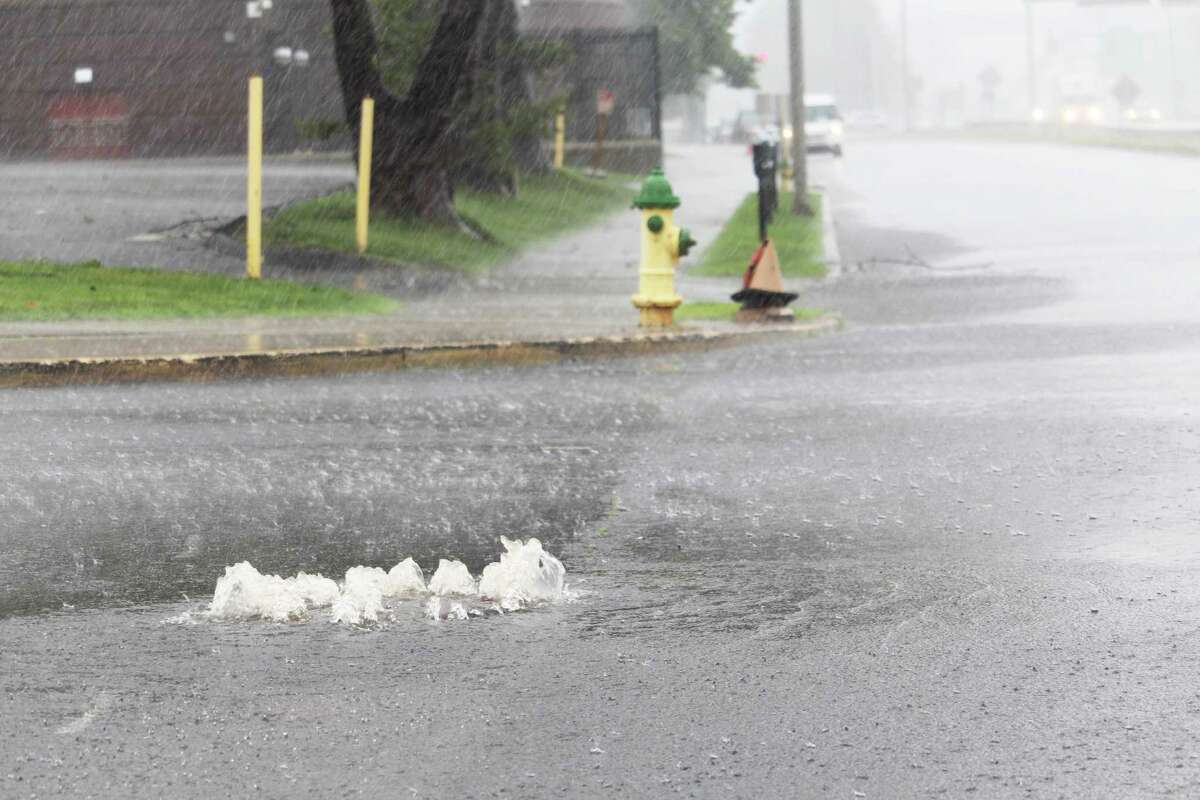 A manhole at the corner of Washington and Newfield streets in Middletown spouts out rains from Tropical Storm Elsa July 9.