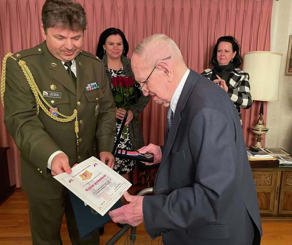 Robert Muthersbaugh, right, receives a medal from Czech Republic officials to honor his role in liberating Czechoslovakia during World War II. Also pictured is Maj. Jan Pekar, a Czech defense attache.