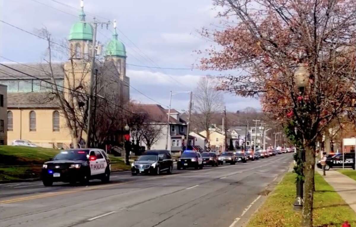 A procession of Danbury police vehicles escrot a hearse carrying Sgt. David Cooney back home to Danbury on Wednesday, Dec. 1, 2021.