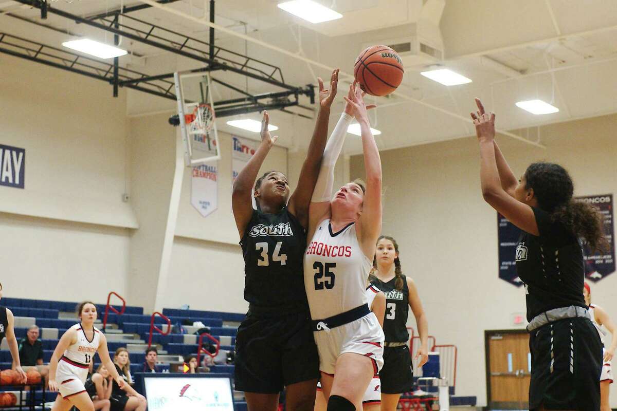 Lutheran South’s Jayla Greer (34) and Bay Area Christian’s Aly Griffith (25) fight for a rebound.