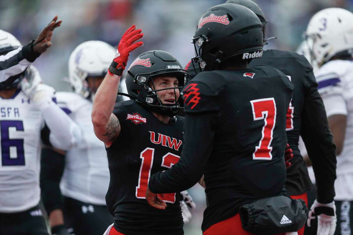 Incarnate Word Cardinals wide receiver Robert Ferrel (12) embraces quarterback Cameron Ward (7) after Ward’s second quarter touchdown in the opening round of the FCS playoffs against the Stephen F. Austin Lumberjacks at Benson Stadium in San Antonio, Texas, Saturday, Nov. 27, 2021.