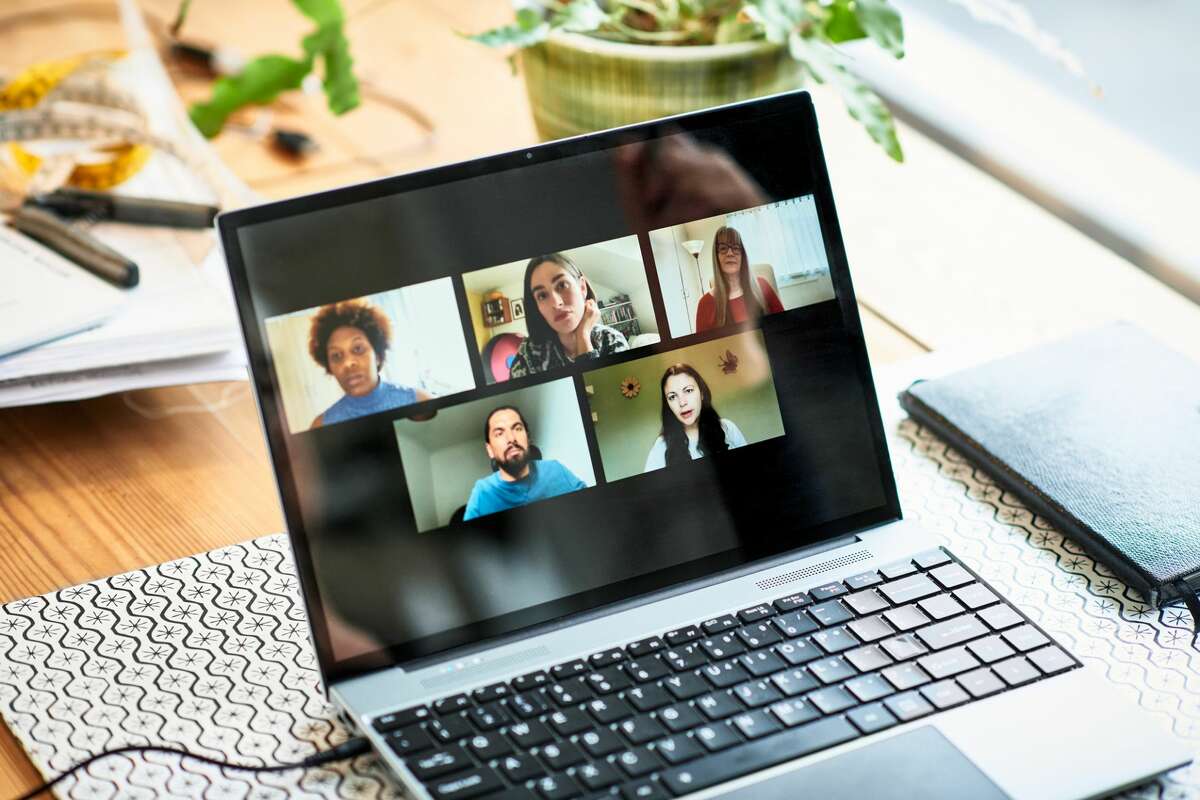 A stock photo of laptop participants on a video conference.