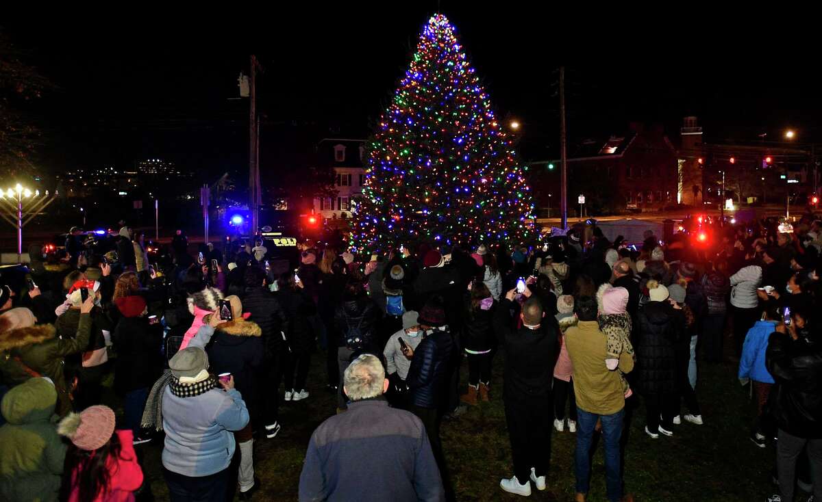 Local residents enjoy the City of Norwalk annual Tree Lighting Celebration Friday on the front lawn of City Hall. Below, the Crystal Theater ensemble perform Christmas Tango.