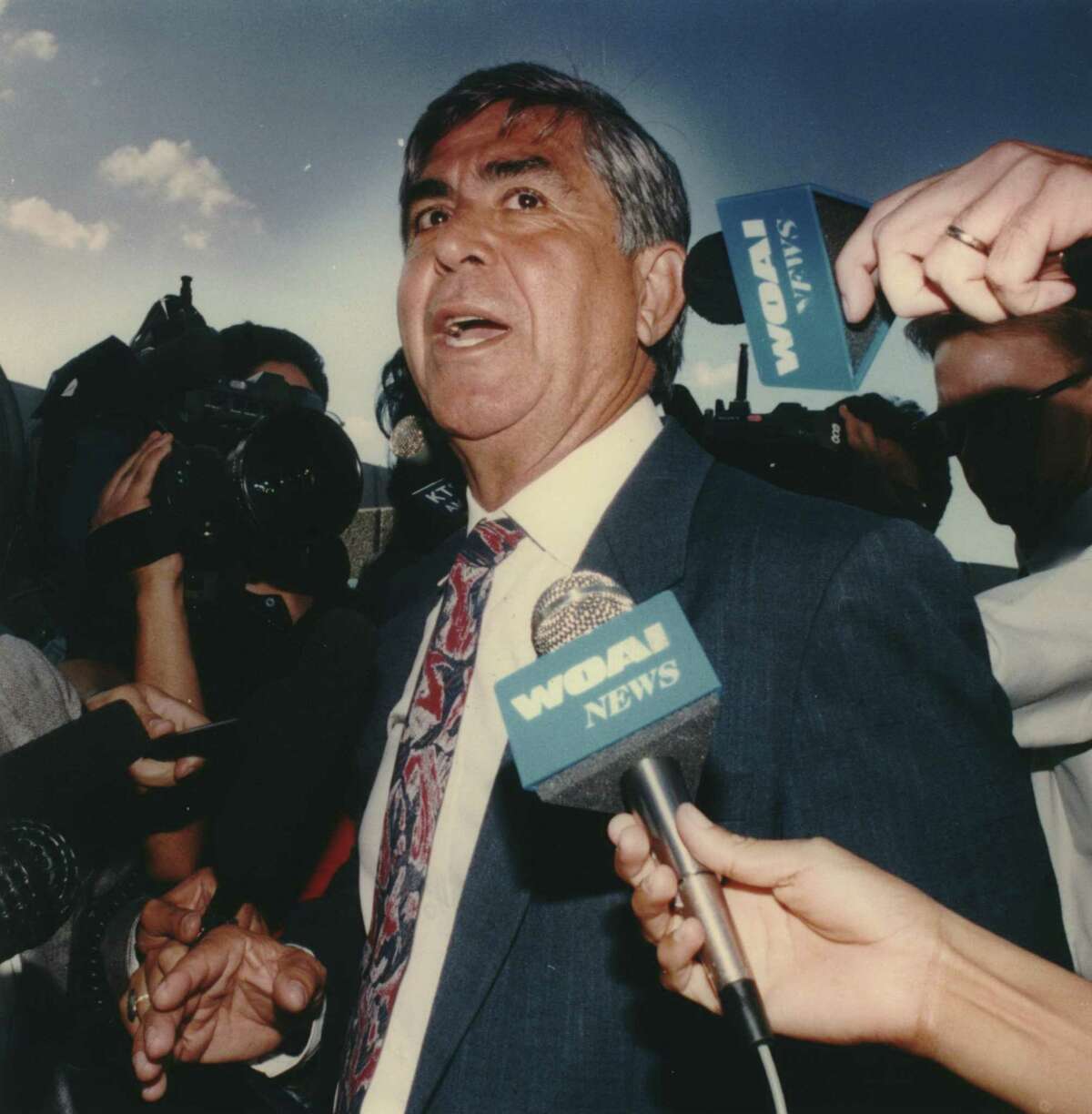 Former U.S. Rep. Albert Bustamante talks to reporters in front of the federal courthouse after being convicted on two bribery-related counts in 1992.