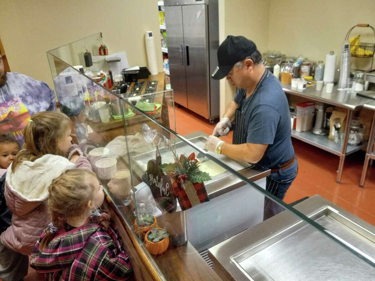 Chris Lee makes a rolled ice cream sundae at Cafe Joie, his ice cream and coffee shop on Main Street, Torrington