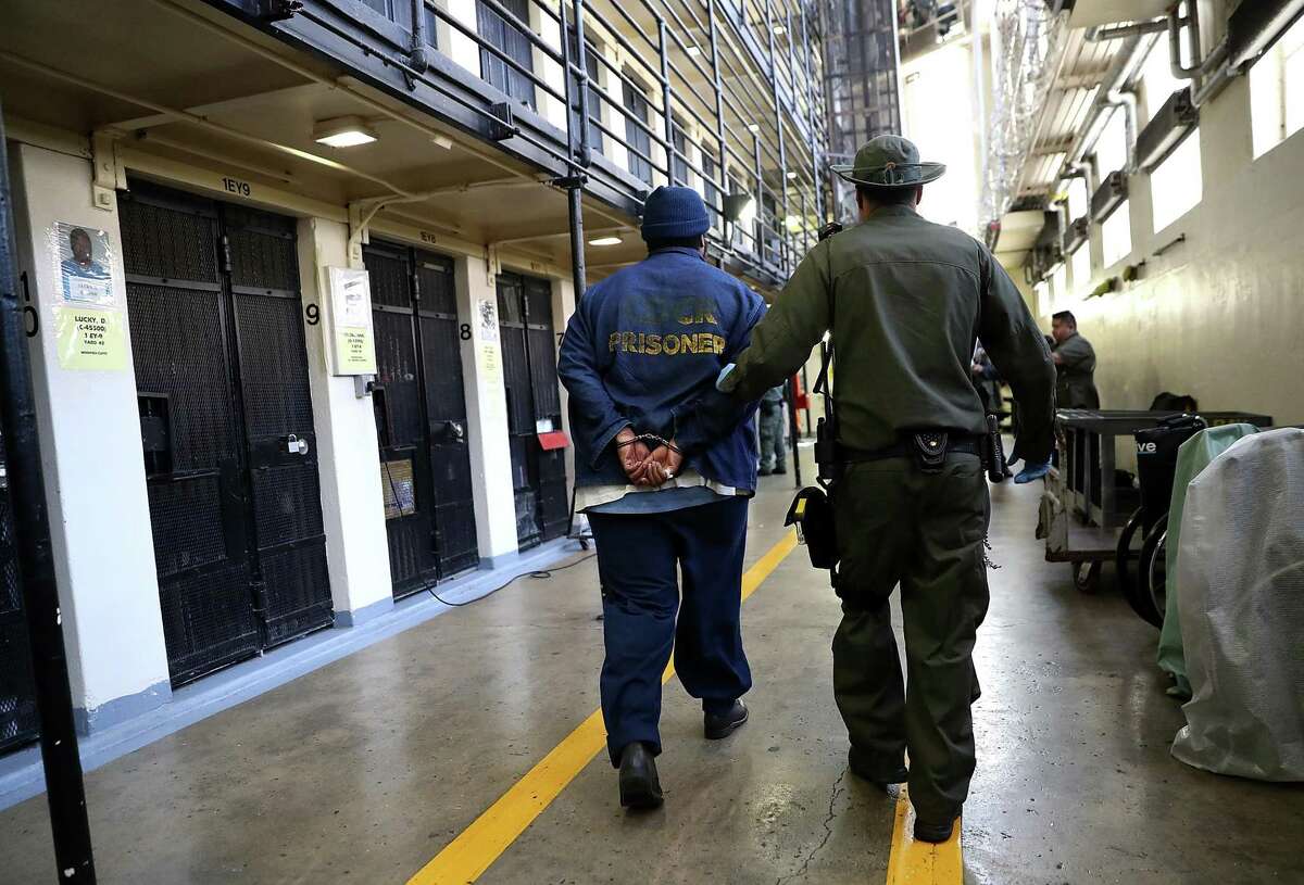 A Department of Corrections officer escorts a condemned inmate at San Quentin State Prison’s death row in 2016.