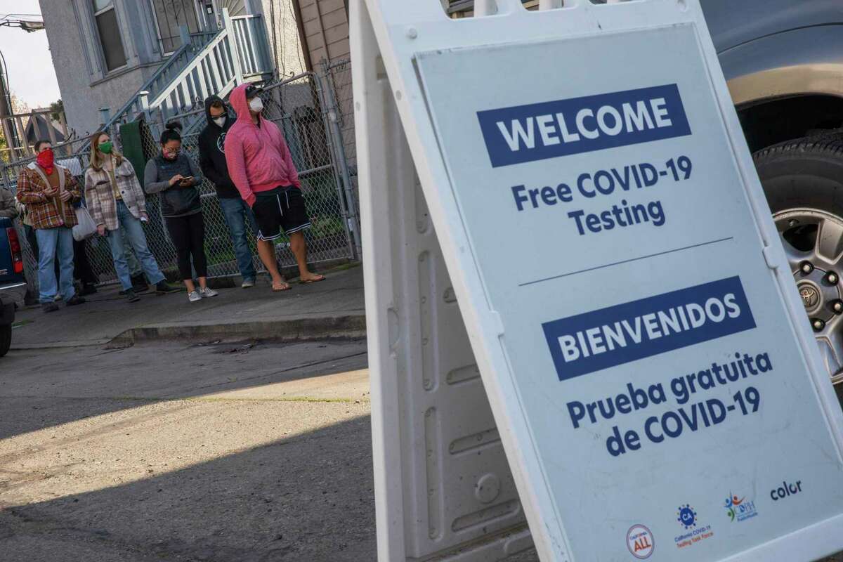 People line up in December for COVID-19 vaccinations at the Community Church in Oakland. The risk of being reinfected with the coronavirus is small, but the omicron variant provided less future immunity than earlier versions.