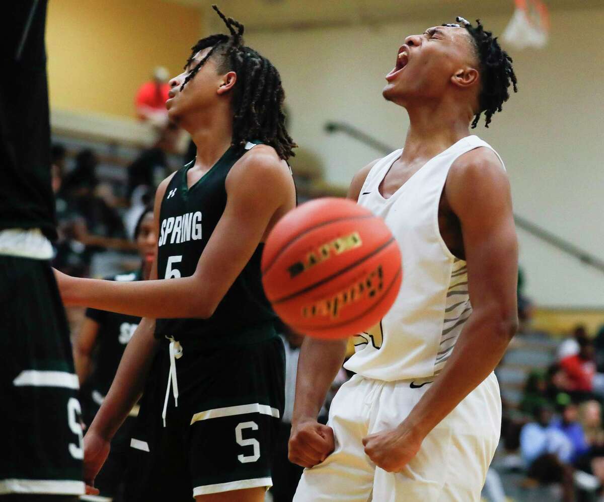Conroe guard Rashaad Salih (24) reacts after draws contact against Spring small forward Xavier Roberts (21) during the first quarter of a non-district high school basketball game at Conroe High School, Friday, Dec. 3, 2021, in Conroe.