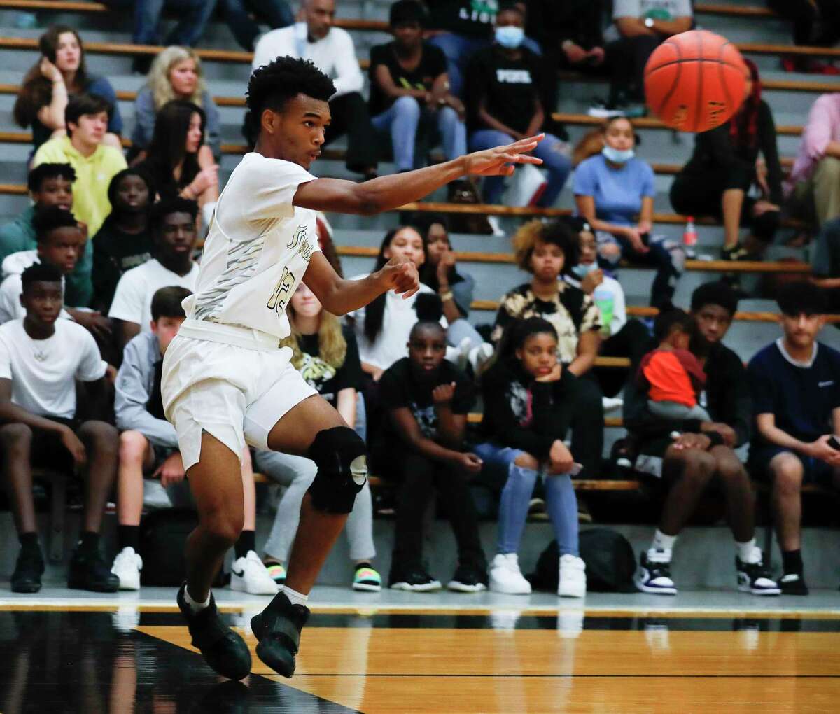Conroe point guard Niglel Leday (12) makes a turnover during the first quarter of a non-district high school basketball game at Conroe High School, Friday, Dec. 3, 2021, in Conroe.