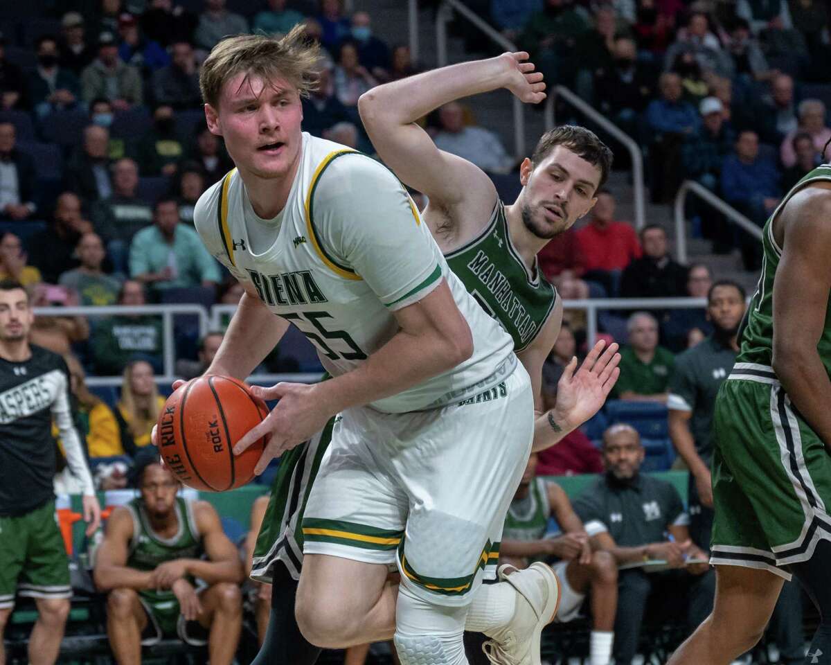 Siena College senior Jackson Stormo looks for help while being defended by Manhattan College senior Nick Brennan during the Metro Atlantic Athletic Conference opener at the Times Union Center in Albany, New York on Friday, Dec. 3, 2021 (Jim Franco/Special to the Times Union)