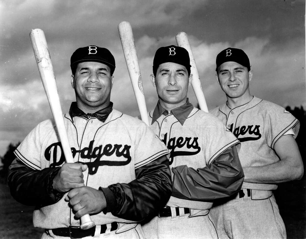 Roy Campanella, left, Carl Furillo, center, and Gil Hodges of the Brooklyn Dodgers pose at Vero Beach, Fla., Feb. 24, 1952. (AP Photo)
