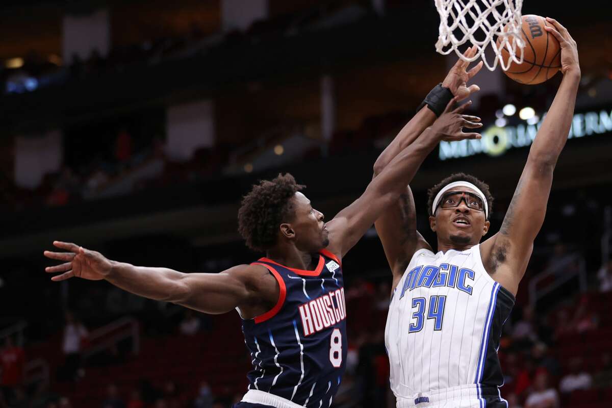 HOUSTON, TEXAS - DECEMBER 03: Wendell Carter Jr. #34 of the Orlando Magic drives to the net against Jae'Sean Tate #8 of the Houston Rockets during the first half at Toyota Center on December 03, 2021 in Houston, Texas. NOTE TO USER: User expressly acknowledges and agrees that, by downloading and or using this photograph, User is consenting to the terms and conditions of the Getty Images License Agreement. (Photo by Carmen Mandato/Getty Images)