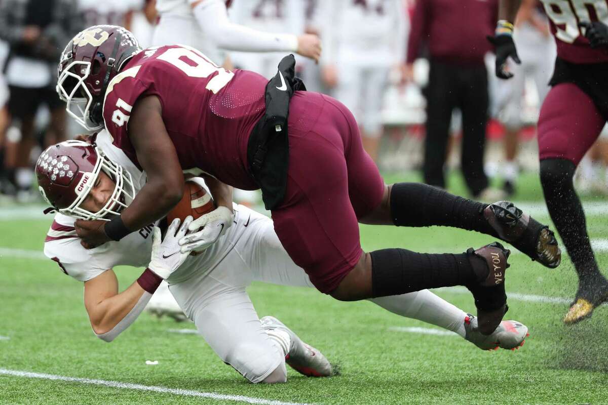 Summer Creek Bulldogs Rocky Jack (91) stops Cinco Ranch Cougars Seth Salverino (3) behind the line of scrimmage for a loss during the first half of a Class 6A Division I regional semifinal high school football game Saturday, Nov. 27, 2021 in Houston.