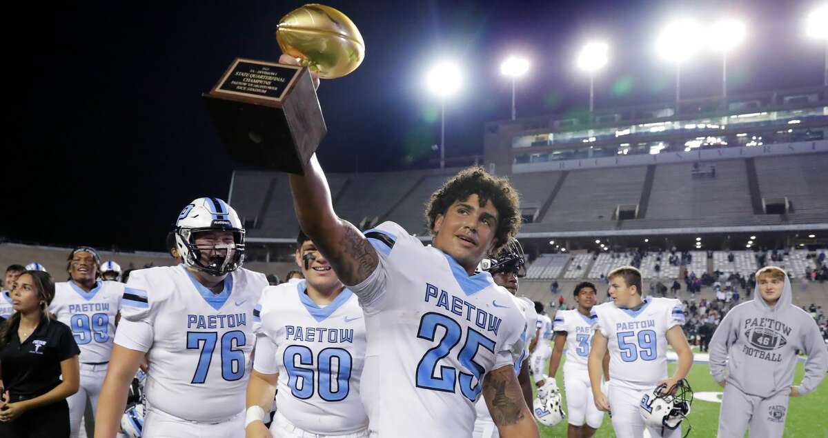 Paetow's Jacob Brown (25) hoists the Regional Trophy with his teammates after defeating Hightower 35-12 after their Region III-5A Division 1 championship high school football game Friday, Dec. 3, 2021 at Rice Stadium in Houston, TX.