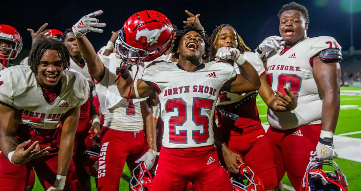 North Shore Mustang RB Treyventa Hillard (25), other players pose for pictures during to the second half of action between North Shore vs. Atascocita Region III-6A Division I championship game at Pasadena ISD Veteran's Memorial Stadium, Friday, December 03, 2021, in Pasadena. North Shore defeated Atascocita 43-20.(Juan DeLeon/Contributor)