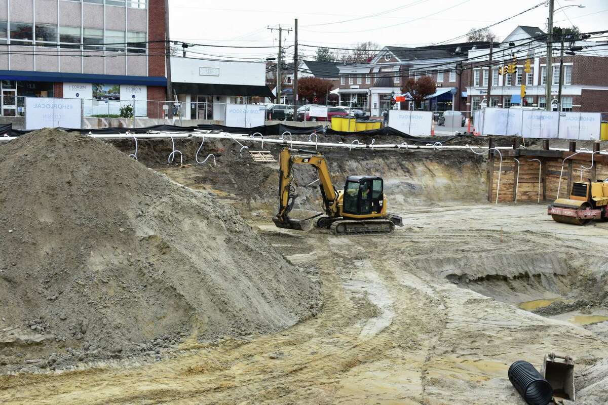 A backhoe operator works at the site for the Corbin District in downtown Darien last month.