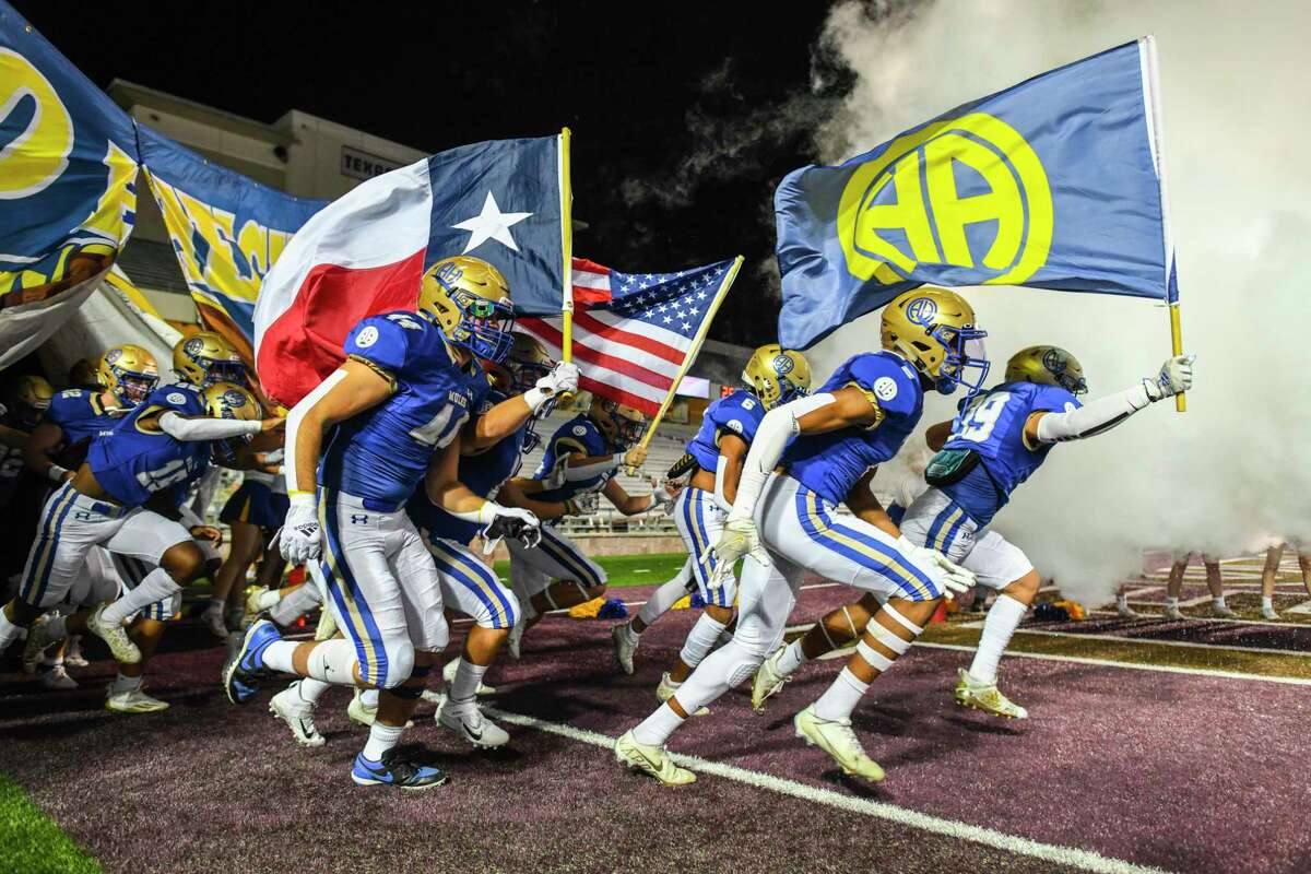 The Alamo Heights Mules enter the Bobcat Stadium field for their 5A-Division 2 regional football final against Liberty Hill in San Marcos on Friday, Dec. 3, 2021.