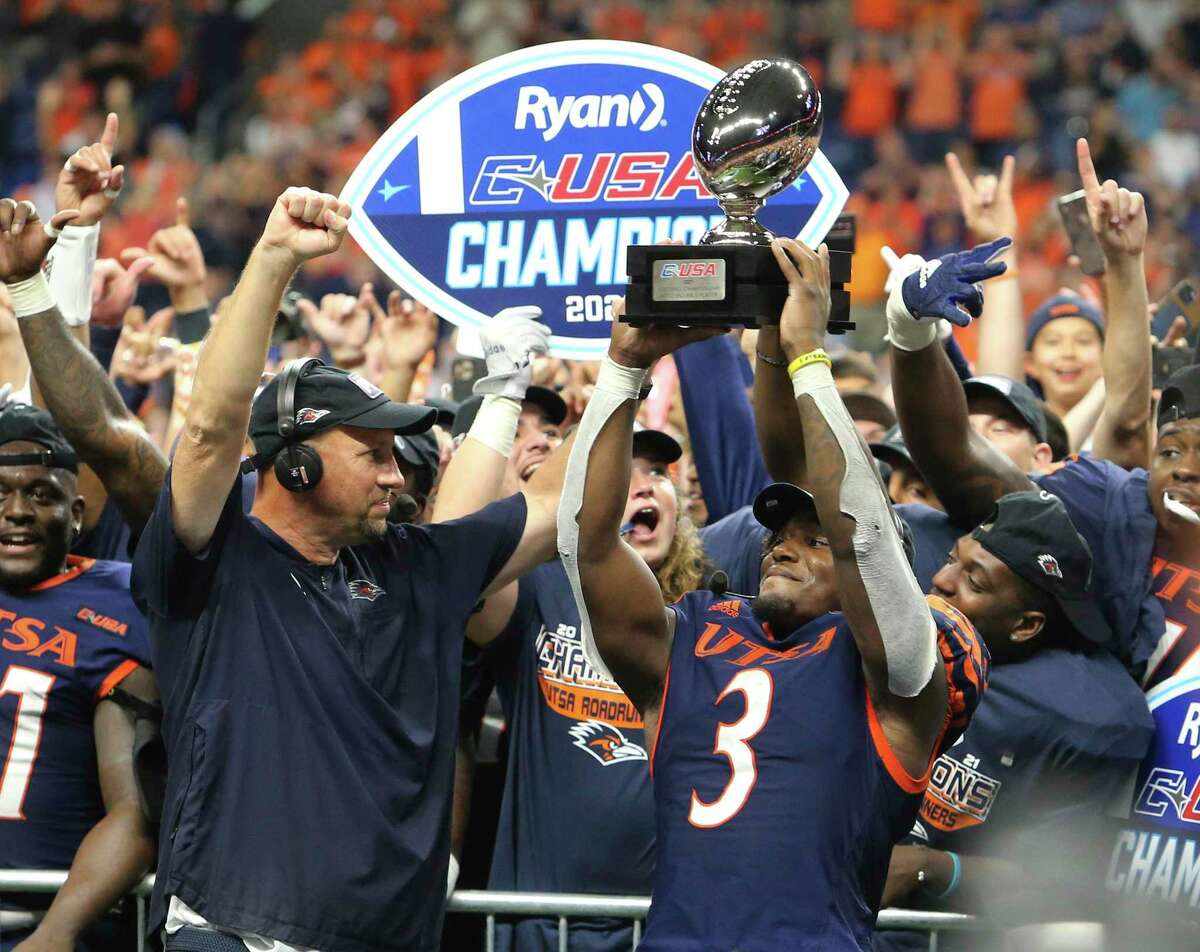 UTSA running back Sincere McCormick (03) and head coach Jeff Traylor celebrate after UTSA defeats Western Kentucky in the 2021 Conference USA Championship football game at the Alamodome on Friday, Dec. 3, 2021. The Roadrunners defeated the Hilltoppers, 49-41, to win the championship. McCormick earned the most valuable player trophy.