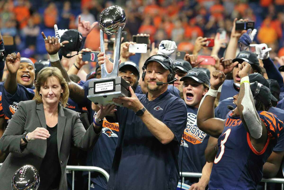 UTSA head coach Jeff Traylor holds the conference trophy after UTSA defeats Western Kentucky in the 2021 Conference USA Championship football game at the Alamodome on Friday, Dec. 3, 2021. The Roadrunners defeated the Hilltoppers, 49-41, to win the championship.
