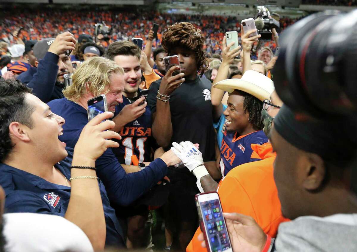 UTSA running back Sincere McCormick (03) gets congratulated after UTSA defeats Western Kentucky in the 2021 Conference USA Championship football game at the Alamodome on Friday, Dec. 3, 2021. The Roadrunners defeated the Hilltoppers, 49-41, to win the championship. McCormick received the most valuable player award.