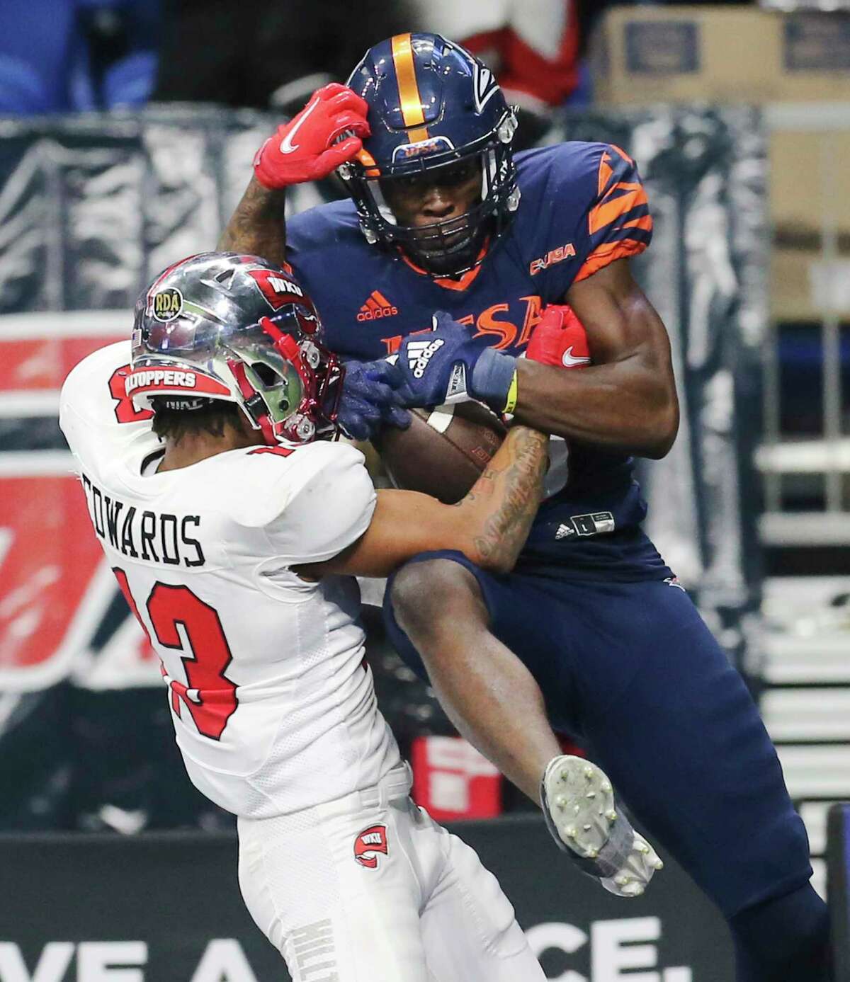 UTSA De’Corian Clark (88) snags a pass for a touchdown against Western Kentucky's Miguel Edwards (13) to extend UTSA's lead in the 4th quarter during the 2021 Conference USA Championship football game at the Alamodome on Friday, Dec. 3, 2021. The Roadrunners defeated the Hilltoppers, 49-41, to win the championship.