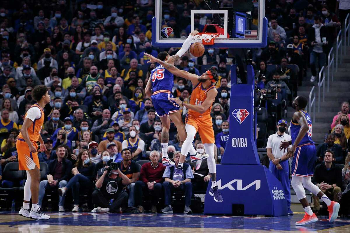 The Warriors’ Juan Toscano-Anderson (95) dunks against JaVale McGee of the Suns in the first quarter Friday at Chase Center.
