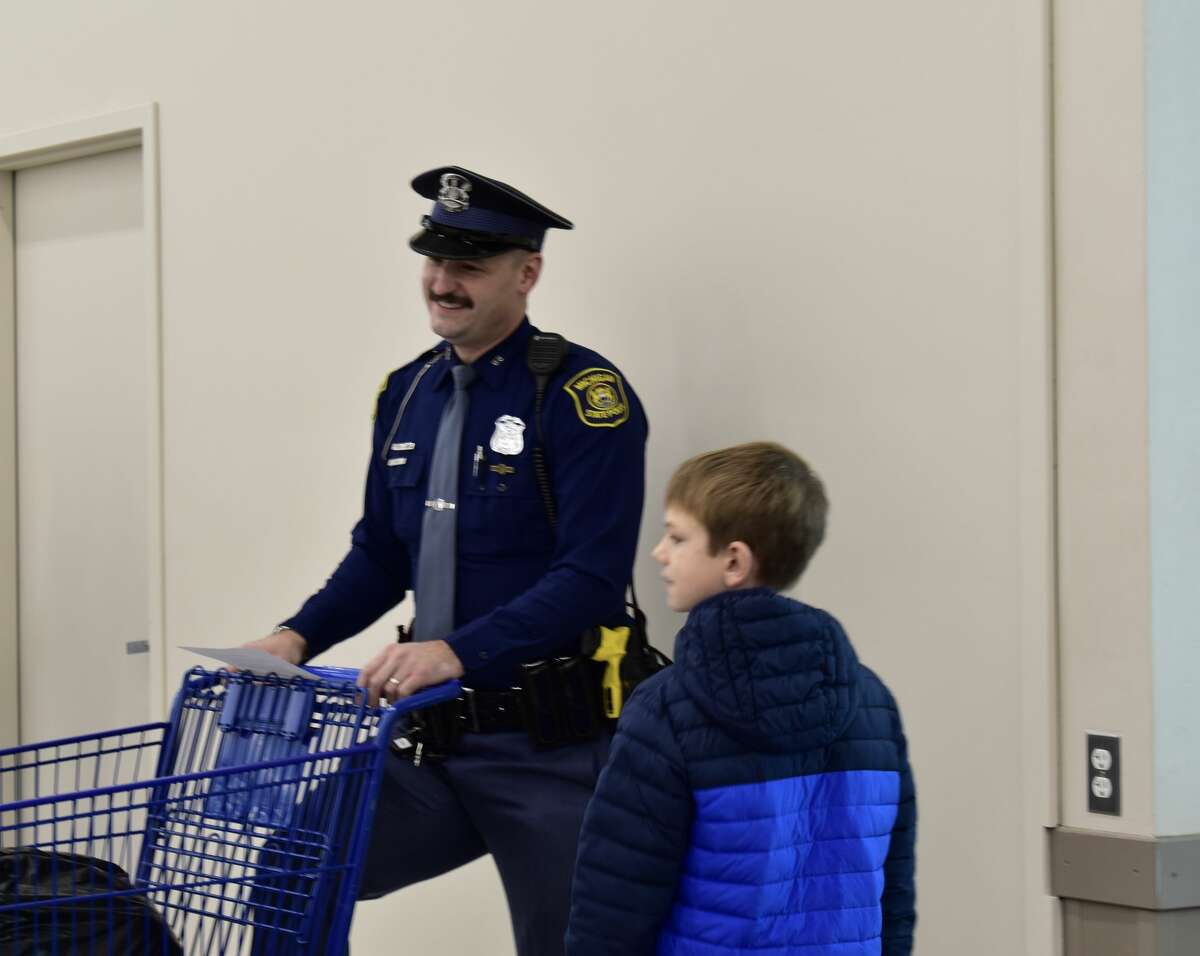 On Dec. 4, the 'Shop with a Hero' program brought kids in need to the Big Rapids Meijer to shop for gifts for their families alongside local public safety officials. 