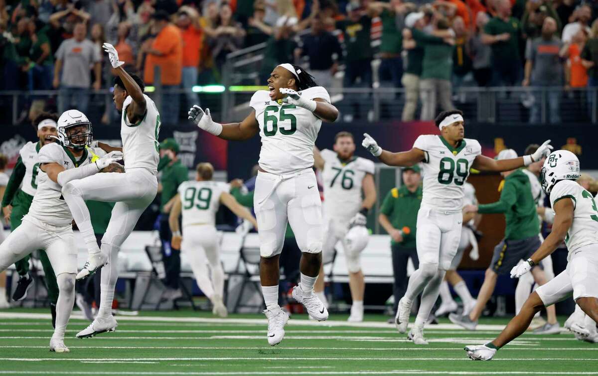 ARLINGTON, TX - DECEMBER 4: Clayton Collier #65 of the Baylor Bears celebrates with teammates after Baylor defeated the Oklahoma State Cowboys 21-16 in the Big 12 Football Championship at AT&T Stadium on December 4, 2021 in Arlington, Texas.