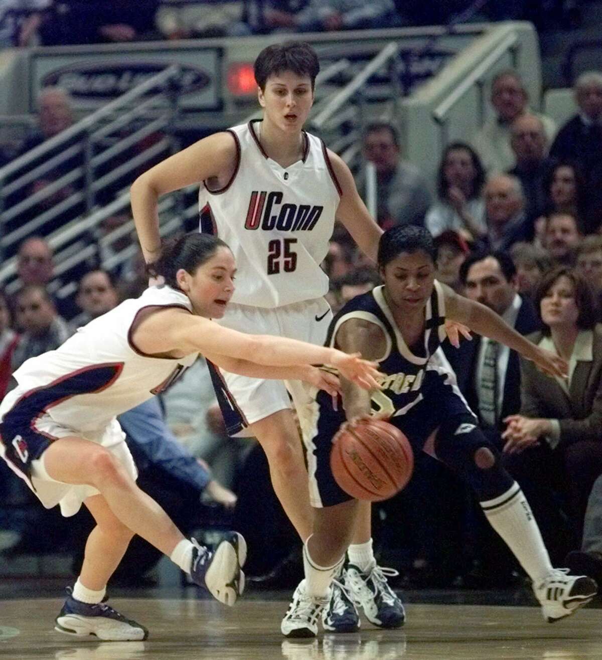UConn’s Sue Bird, left, reaches in to stop Notre Dame’s Niele Ivey as UConn’s Svetlana Abrosimova (25) comes in on the play in the first half in 2000.