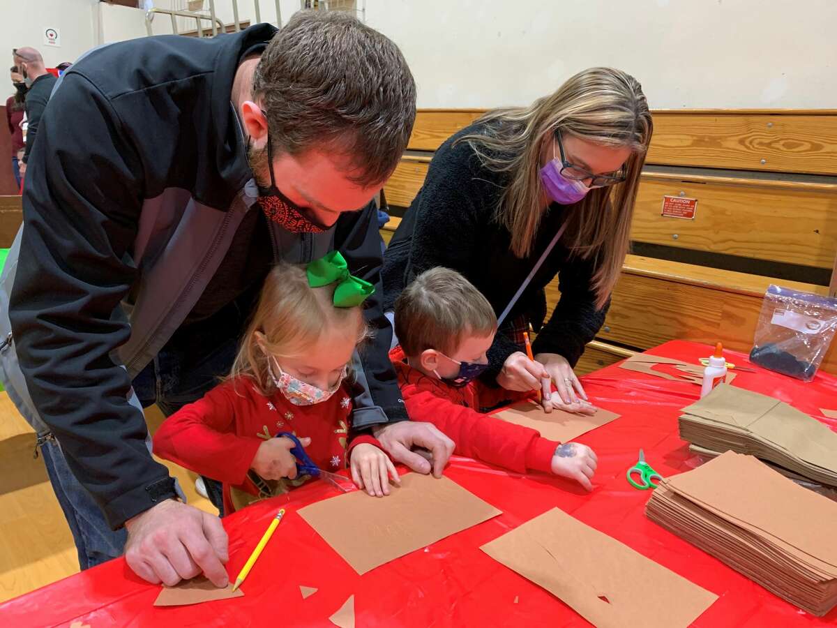 The Goebel family enjoying some arts and crafts at the St. Mary's Breakfast with Santa event on Saturday in the St. Mary's gymnasium. Along with arts and crafts, there were games, a hot cocoa bar, a pancake breakfast and pictures with Santa. 